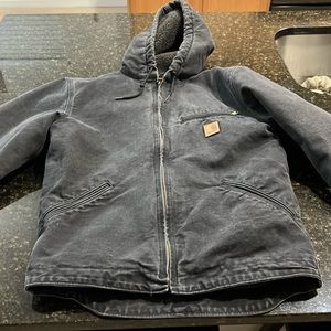 Big boys size small black fleece lined hooded Carhartt jacket.